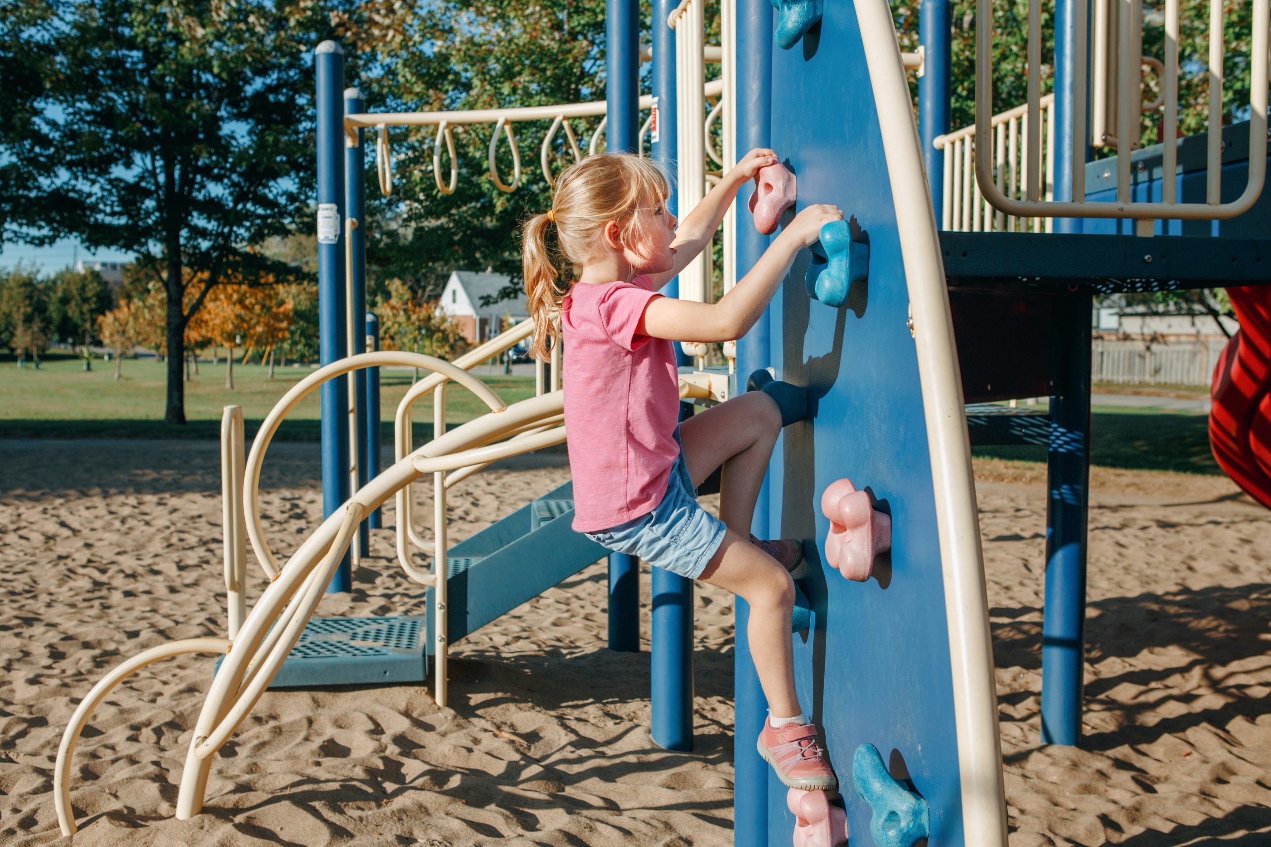 Young child playing happily outdoors in nature